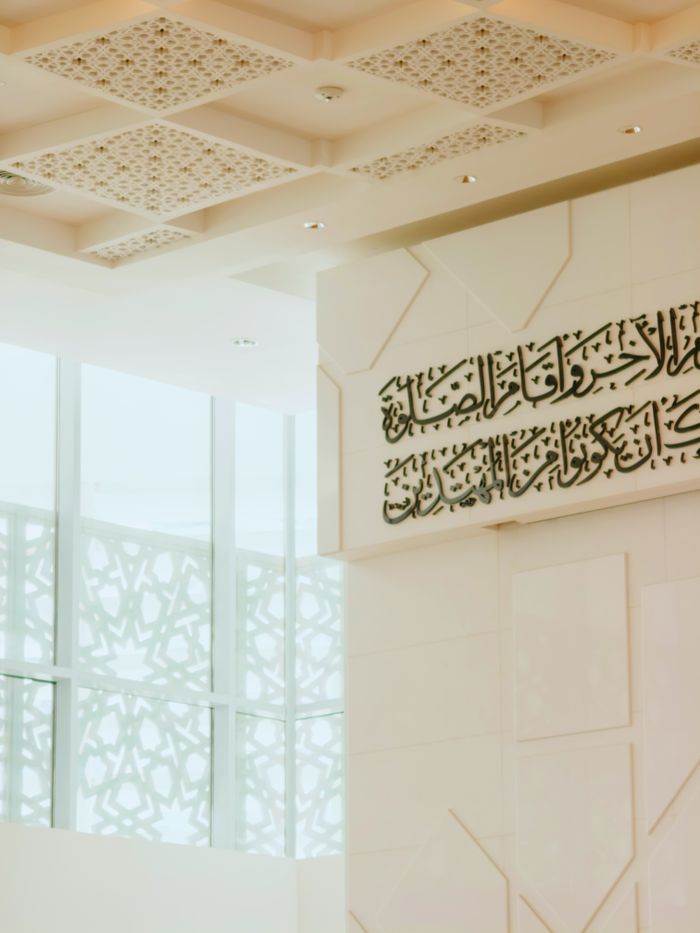 Elegant interior design of a mosque in Malaysia showcasing Islamic calligraphy and motifs.
